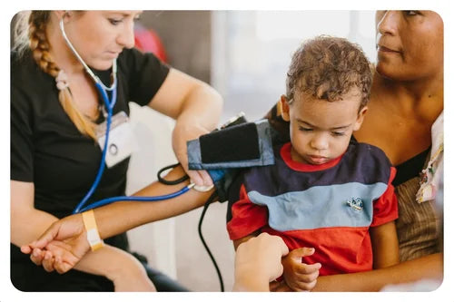 Child being examined by a healthcare professional with a stethoscope