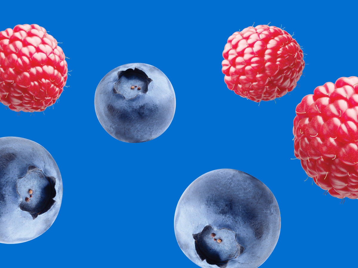 Blueberries and raspberries on a blue background